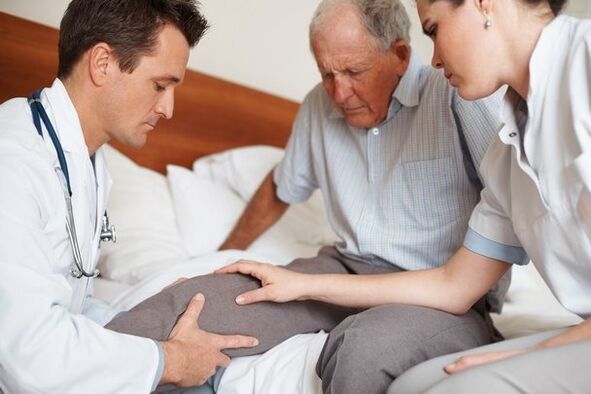 Doctor examining patient's knee